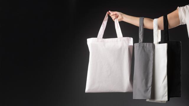 Canvas bag customized being held by guy in black shirt